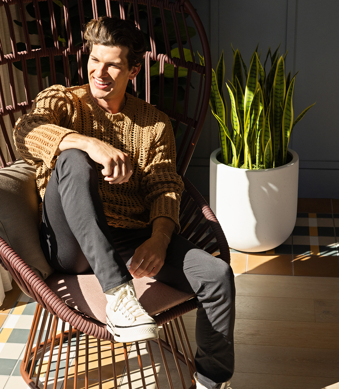 A man sitting in a chair outside