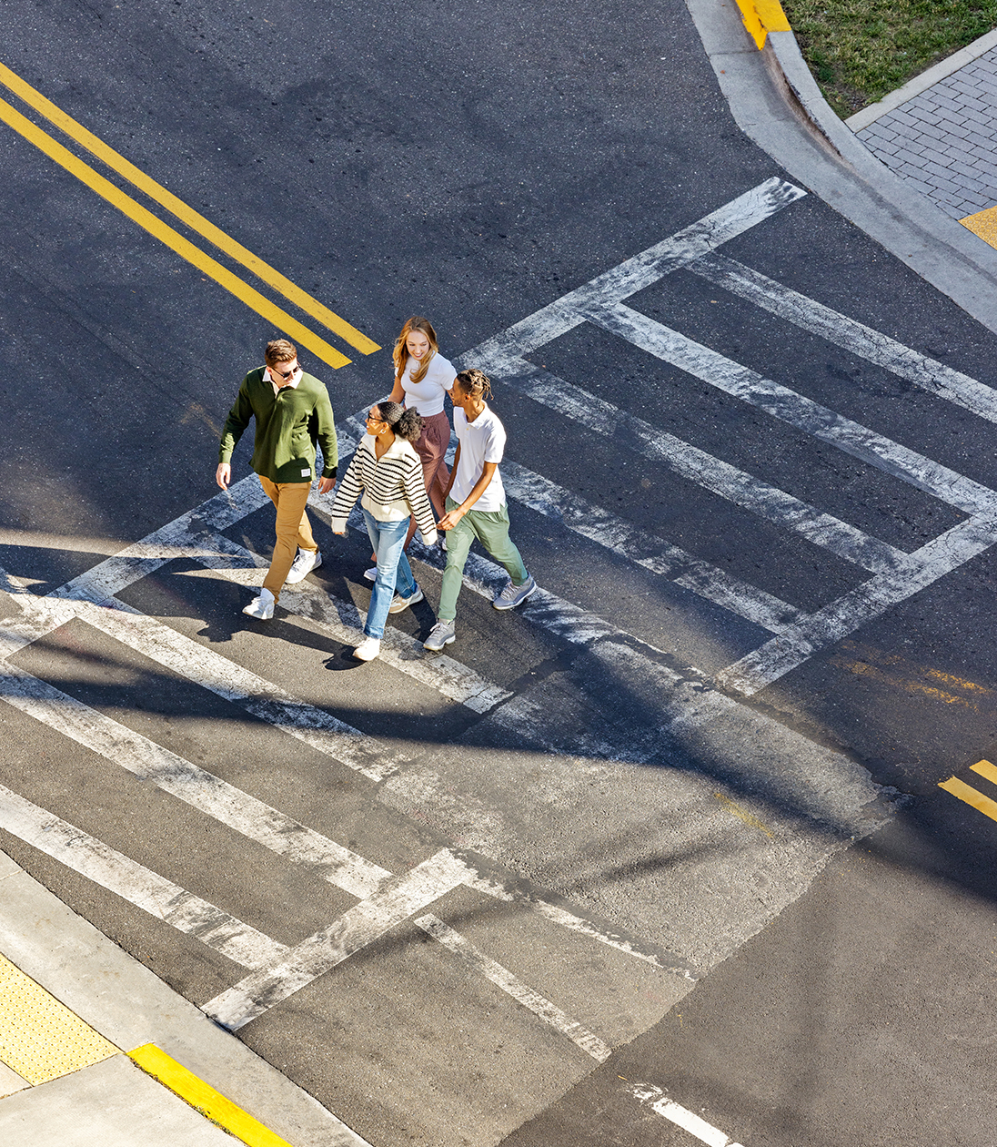 A group of friends walking across the street